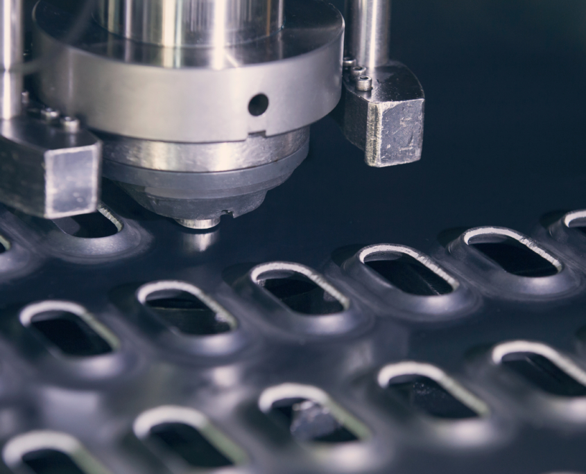 Rotation CNC Punching & Nibbling Machine in action. Metal perforating industrial machine.